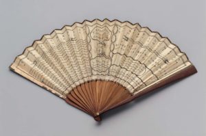 Wooden and paper fan splayed open on white background