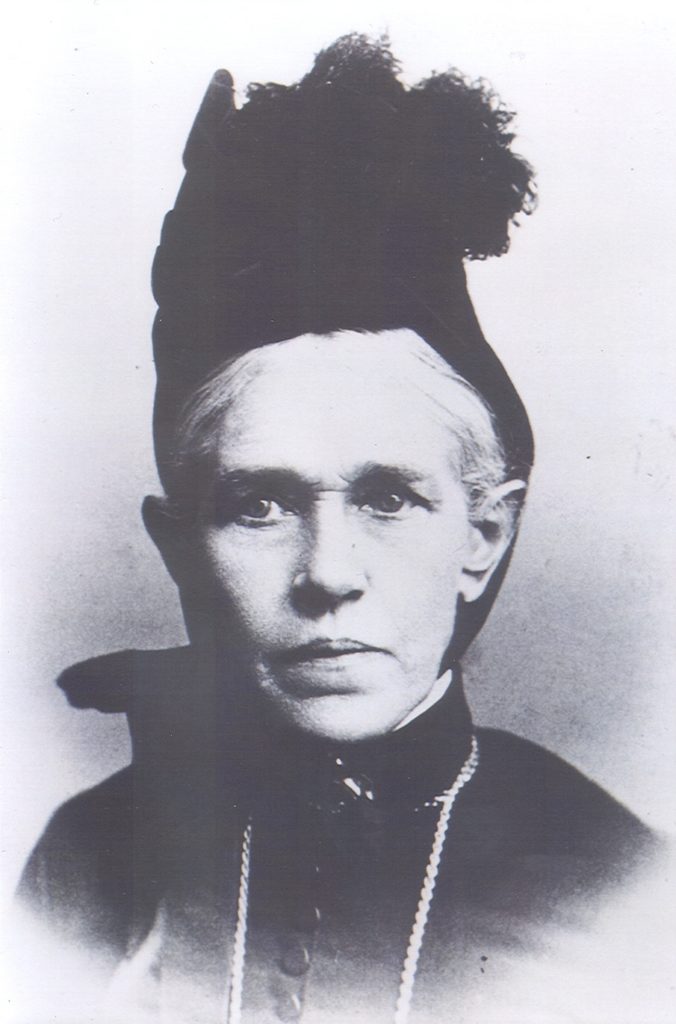 Black and white photograph of Johanna Collins Tobin from the shoulders up. She is wearing black and a small black hat.