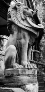 Sculpture of a sitting lion outside the Molly Brown House. Black and white photo
