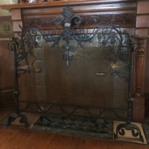 Ornate iron and copper fireplace screen.