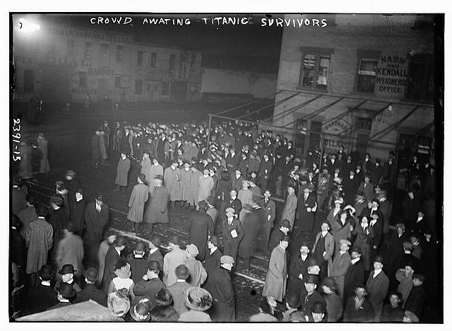 a group of people standing in front of a crowd posing for the camera