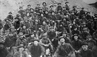 a group of people posing for a photo in front of a crowd