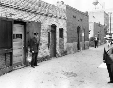 a person walking down a street next to a building