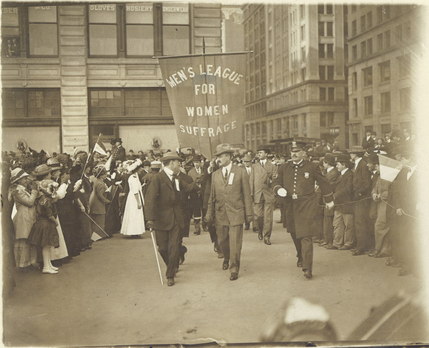 a vintage photo of a group of people standing in front of a building