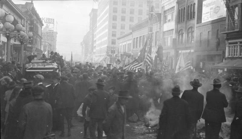 a group of people walking on a city street