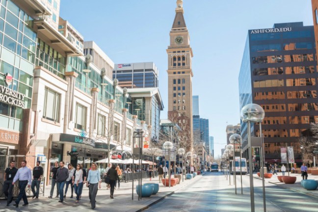 a group of people walking on a city street