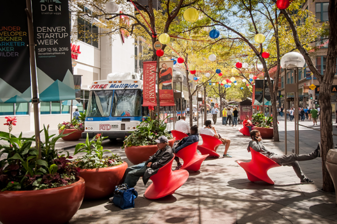 a close up of an umbrella on a city street