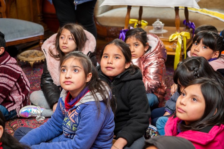 a group of young children sitting next to a child