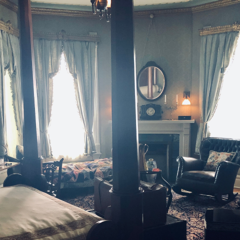 a living room filled with furniture and a large window