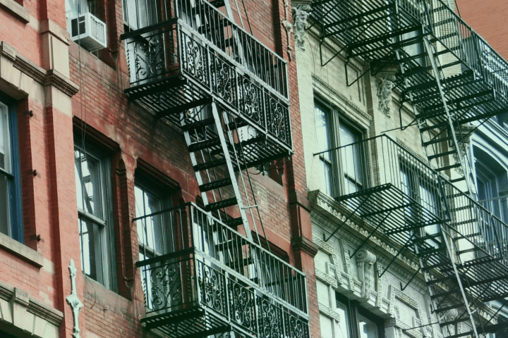 Close-up of urban buildings with metal fire escapes.